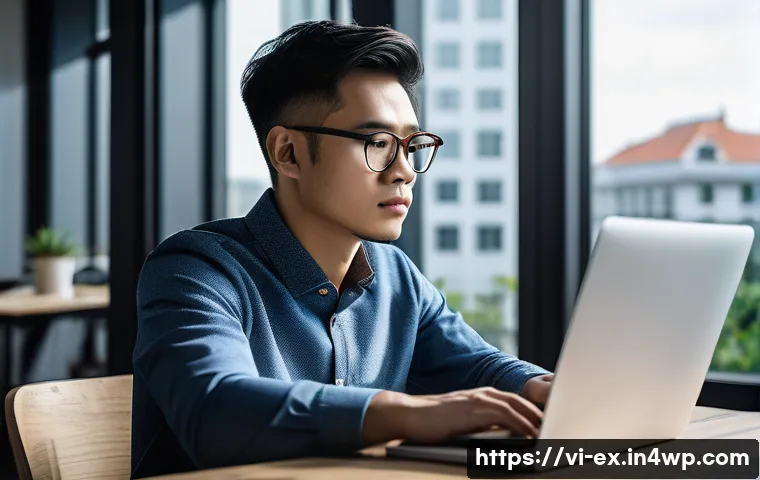 T자형 전문성 개발을 위한 혁신적 접근 - A focused Vietnamese IT professional in a modern coworking space, deeply engaged in coding on a lapt...